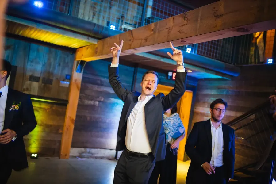 Wedding guests celebrating on the dance floor with Michael Sage
