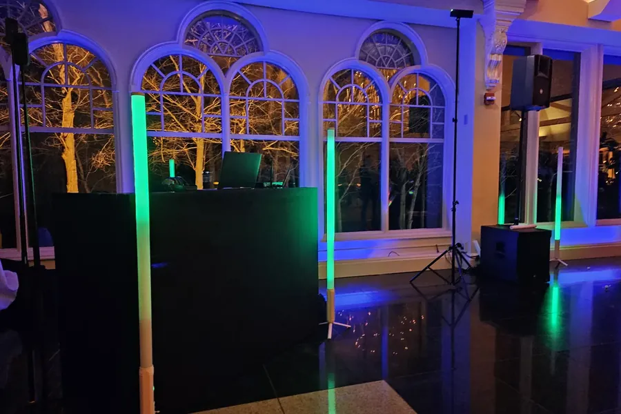 Michael Sage's DJ booth with uplighting before a wedding reception