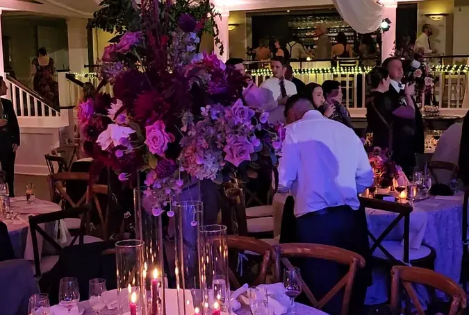 Reception tables with uplighting at a Michael Sage wedding