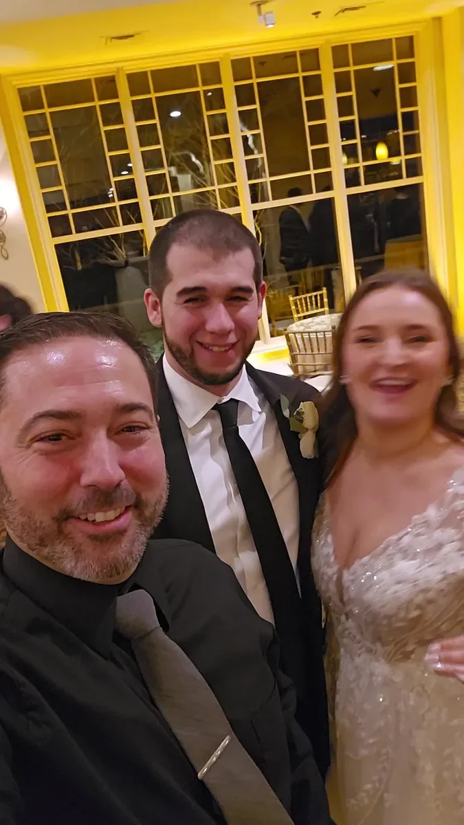 Michael Sage, Westport wedding DJ and MC, taking a selfie with a bride and groom at their reception